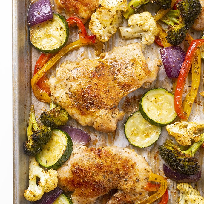 烤箱烤的无骨鸡腿和蔬菜放在烤盘上